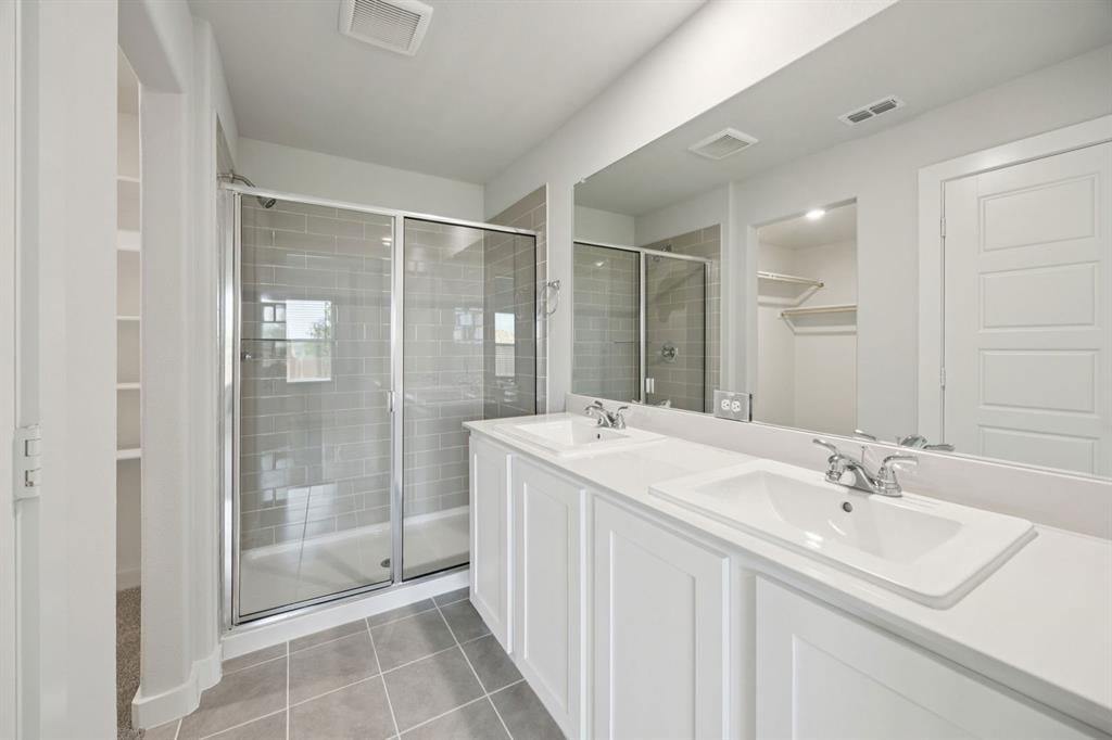 1868 Gallop Road Seagoville, TX 75159 - Photo 13 of 27 a bathroom with a shower sink and mirror