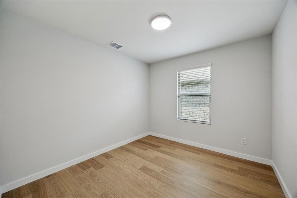 1868 Gallop Road Seagoville, TX 75159 - Photo 19 of 27 an empty room with wooden floor and windows