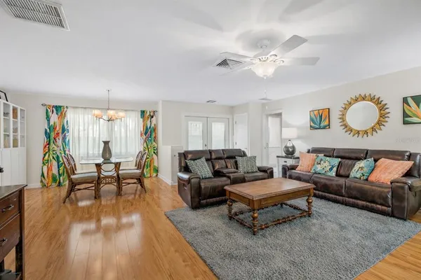 a living room with furniture and wooden floor