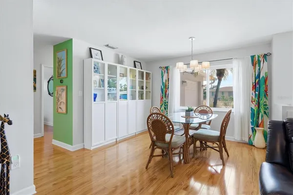 a view of a dining room with furniture window and wooden floor