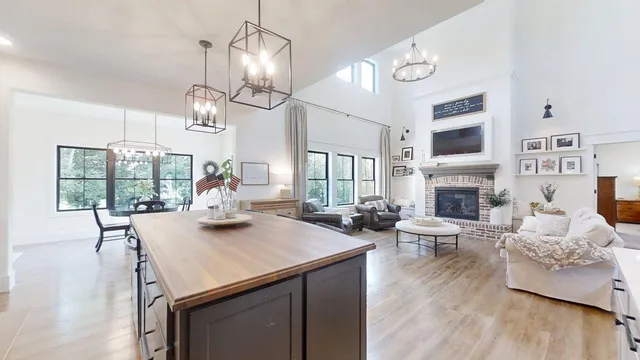 a view of a dining room with furniture wooden floor and chandelier
