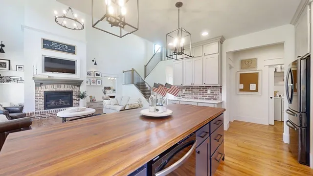 a view of a dining room with furniture wooden floor and a chandelier