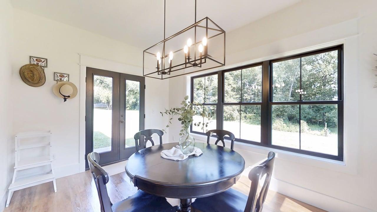 7845 Fitzgerald Road Clinton, IL 61727 - Photo 17 of 62 a dining room with furniture a chandelier and wooden floor