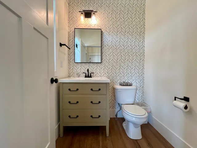 a bathroom with a toilet sink and mirror