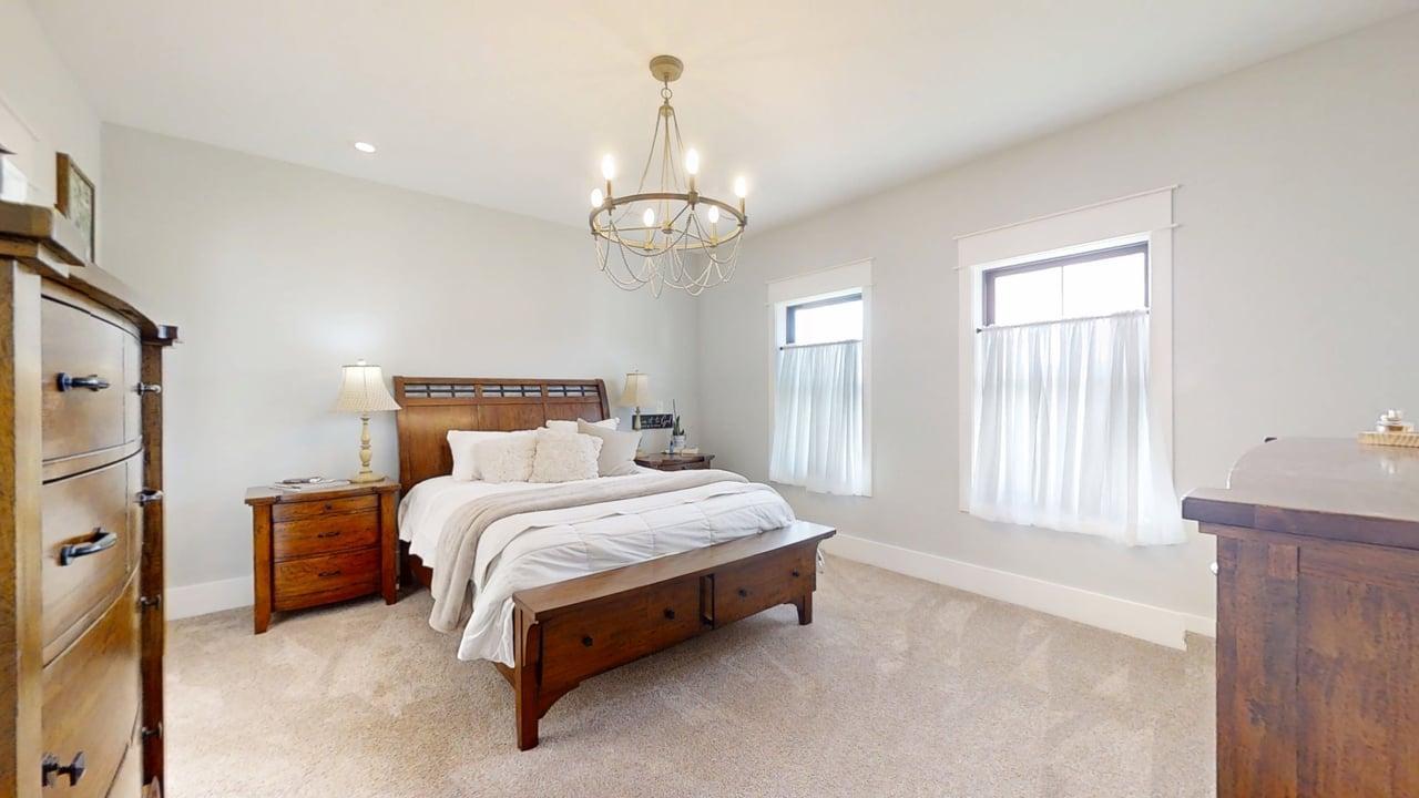 7845 Fitzgerald Road Clinton, IL 61727 - Photo 21 of 62 a spacious bedroom with a bed chandelier and window