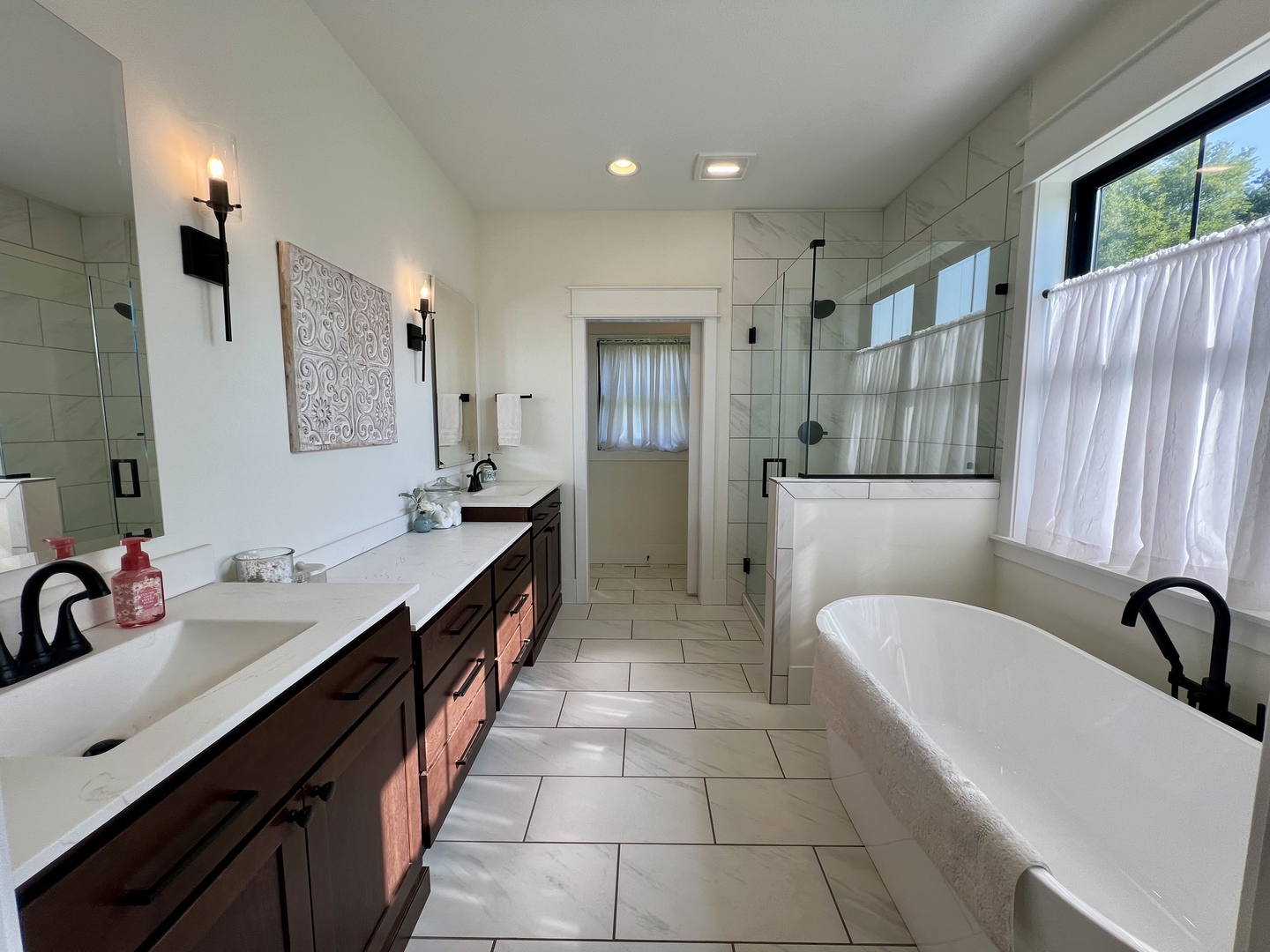 7845 Fitzgerald Road Clinton, IL 61727 - Photo 25 of 62 a spacious bathroom with a double vanity sink a mirror and a bathtub