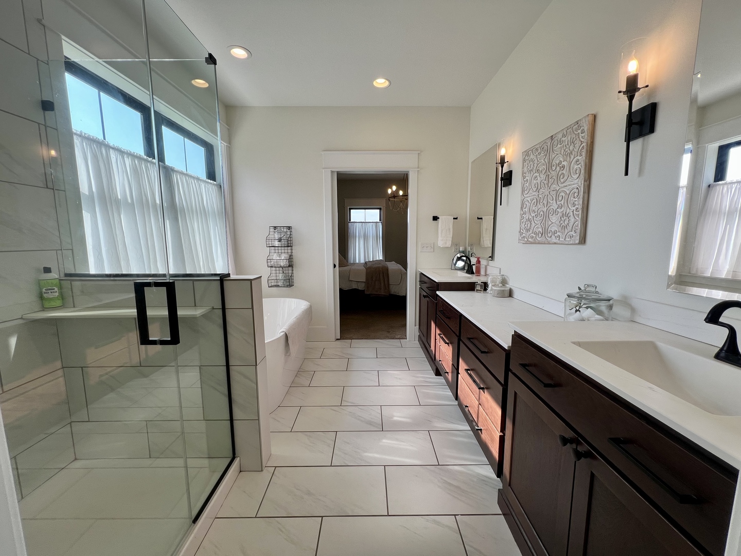 7845 Fitzgerald Road Clinton, IL 61727 - Photo 28 of 62 a large bathroom with a double vanity sink a large mirror and a shower