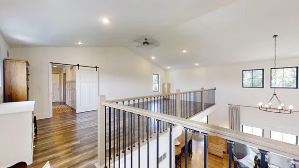 a kitchen with granite countertop a white stove top oven cabinets and wooden floor