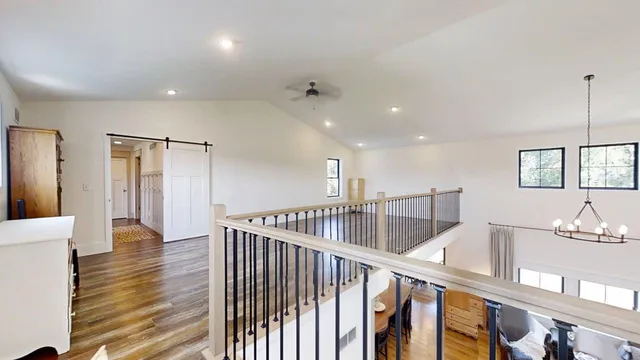 a kitchen with granite countertop a white stove top oven cabinets and wooden floor
