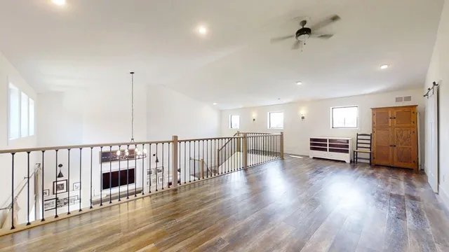 a large kitchen with a lot of counter space and wooden floor