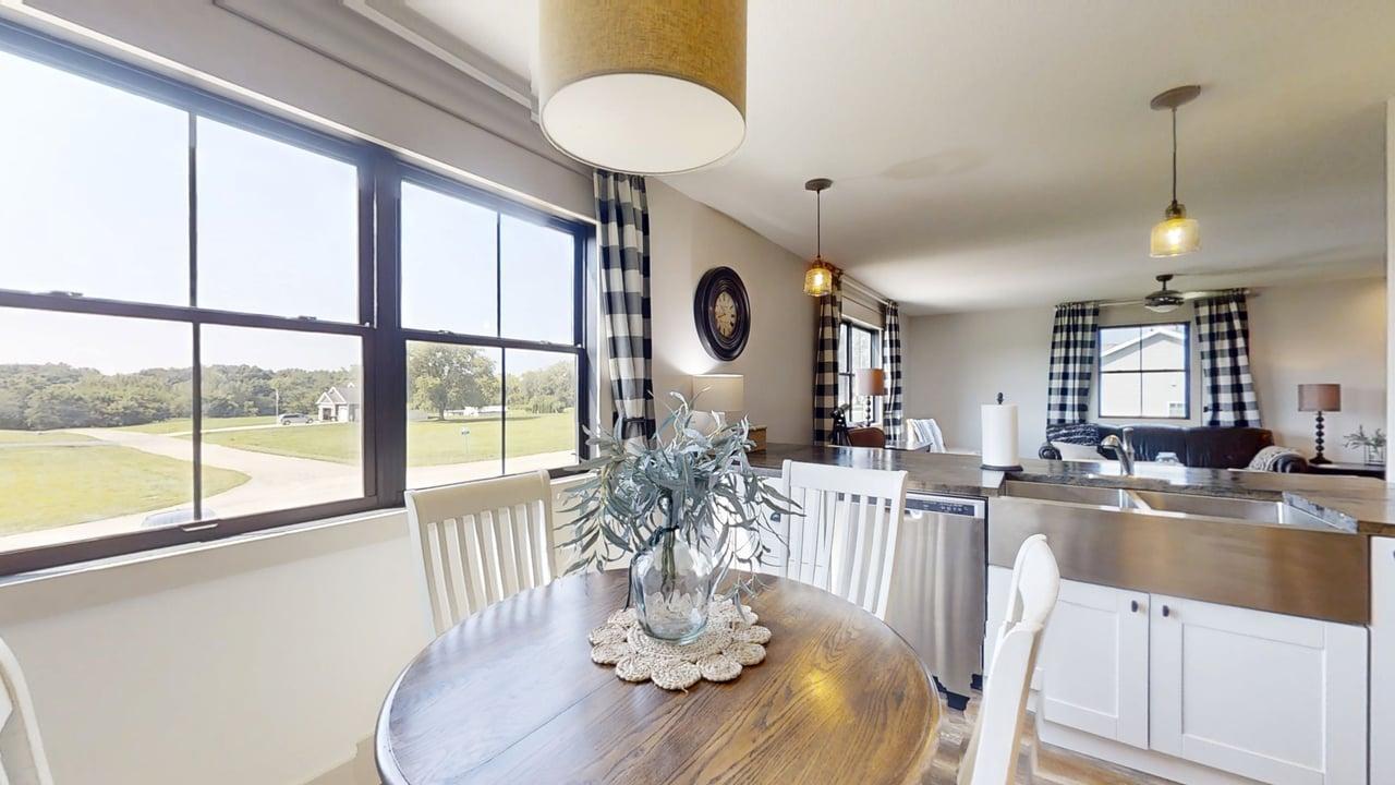 7845 Fitzgerald Road Clinton, IL 61727 - Photo 35 of 62 a dining room with wooden floor a chandelier a glass table and chairs