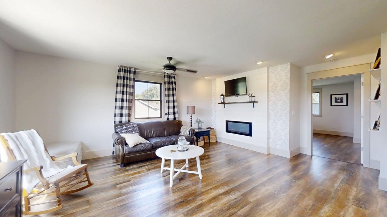 7845 Fitzgerald Road Clinton, IL 61727 - Photo 39 of 62 a living room with furniture a fireplace and a flat screen tv