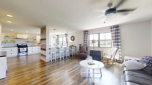 a bedroom with a bed and painting on the wall