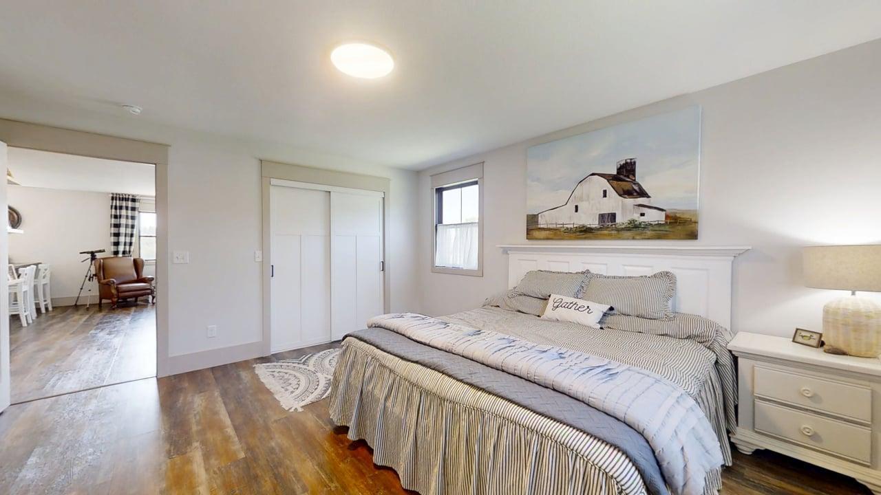 7845 Fitzgerald Road Clinton, IL 61727 - Photo 44 of 62 a bedroom with a bed and wooden floor