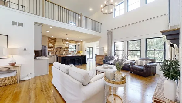 a living room with furniture or kitchen and a chandelier