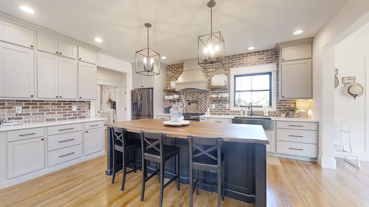 7845 Fitzgerald Road Clinton, IL 61727 - Photo 10 of 62 a kitchen with stainless steel appliances kitchen island granite countertop a table chairs and white cabinets