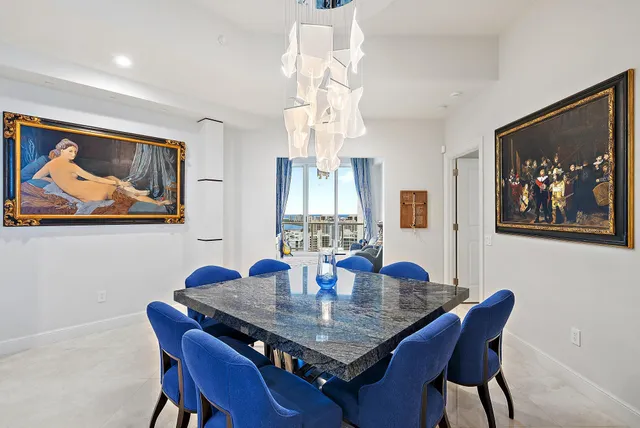 a dining room with furniture a chandelier and wooden floor