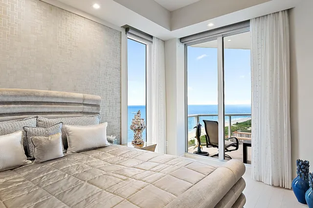 a bedroom with a large bed and a large window