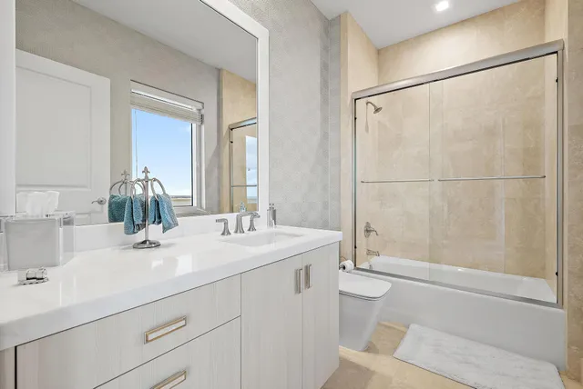 a bathroom with a sink toilet and shower