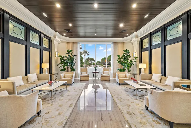 a living room with furniture and large windows