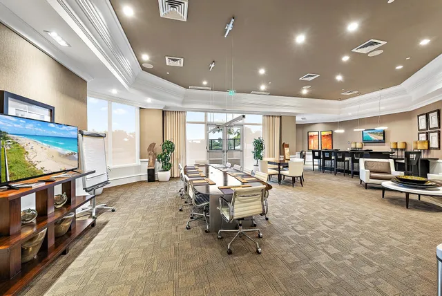 a living room with furniture a flat screen tv and a table