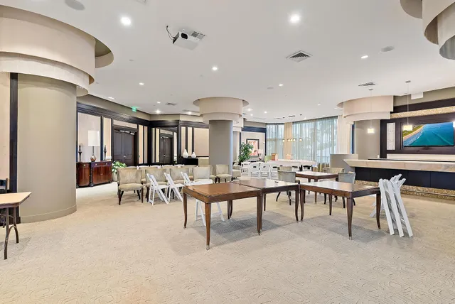 a living room with lots of furniture and a large window