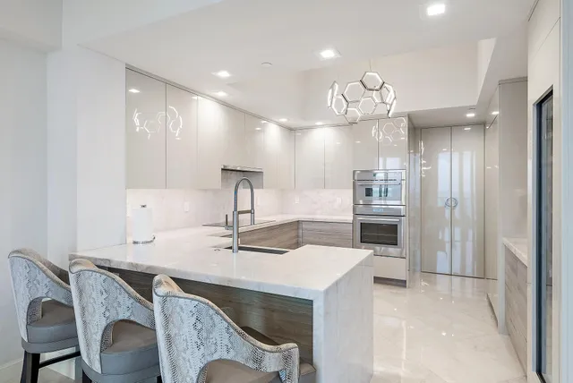 a kitchen with kitchen island a sink appliances and cabinets