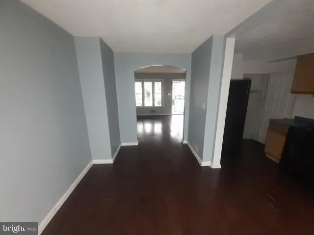 a kitchen with wooden floor and windows