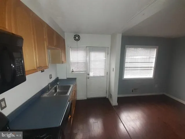 a kitchen with a refrigerator and a stove top oven