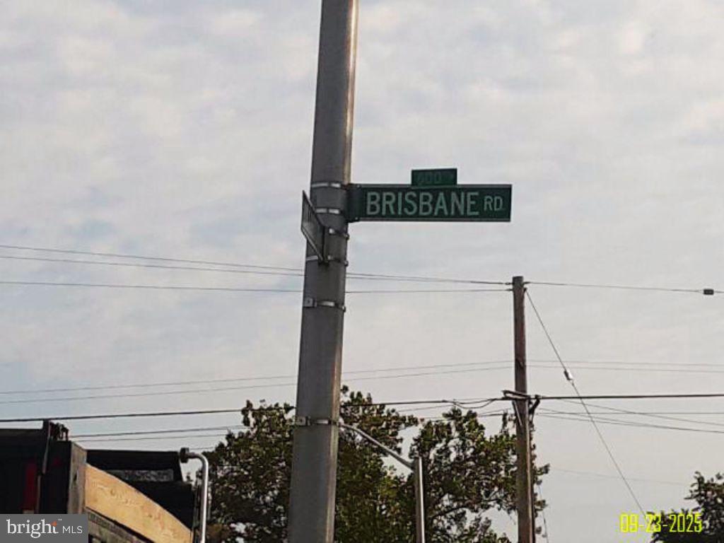 617 Brisbane Road Baltimore, MD 21229 - Photo 6 of 15 a street sign on a pole next to road