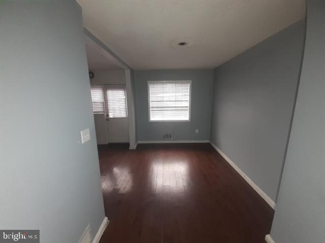 617 Brisbane Road Baltimore, MD 21229 - Photo 9 of 15 an empty room with wooden floor and windows