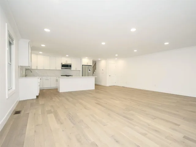 a kitchen with stainless steel appliances white cabinets and a stove