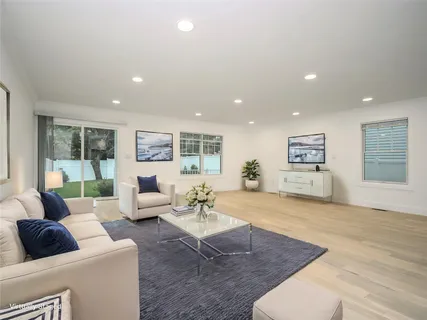 a view of a dining room with furniture and a kitchen