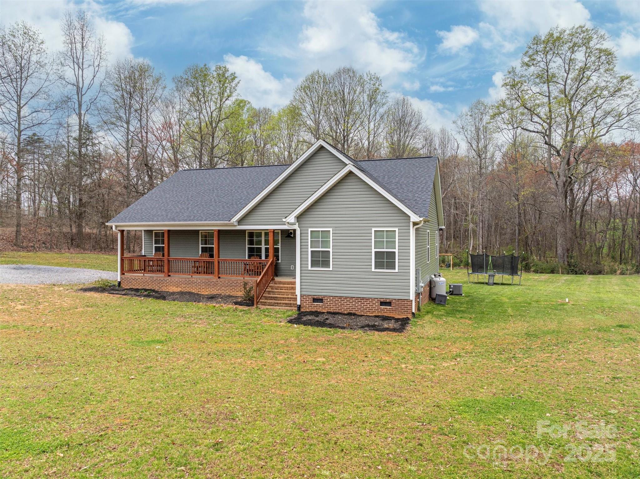 7430 Houser Farm Road Cherryville, NC 28021 - Photo 2 of 22 a front view of a house with a yard table and chairs