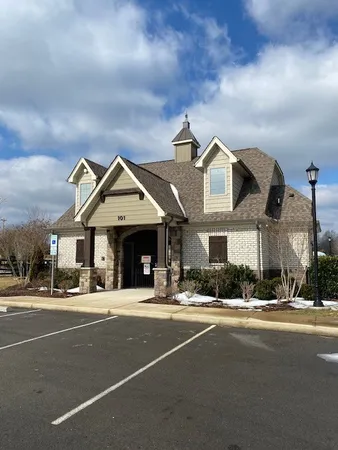 a view of a swimming pool with a bench and lawn chairs