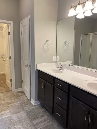 a bathroom with a sink vanity and mirror