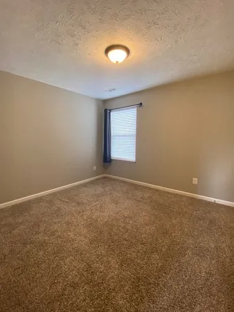an empty room with a empty space and windows