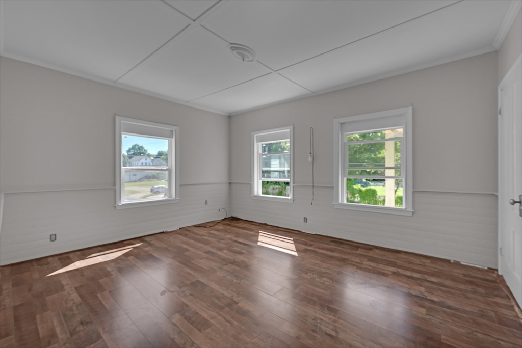 47 Morris Street Southbridge, MA 01550 - Photo 11 of 40 an empty room with wooden floor and windows