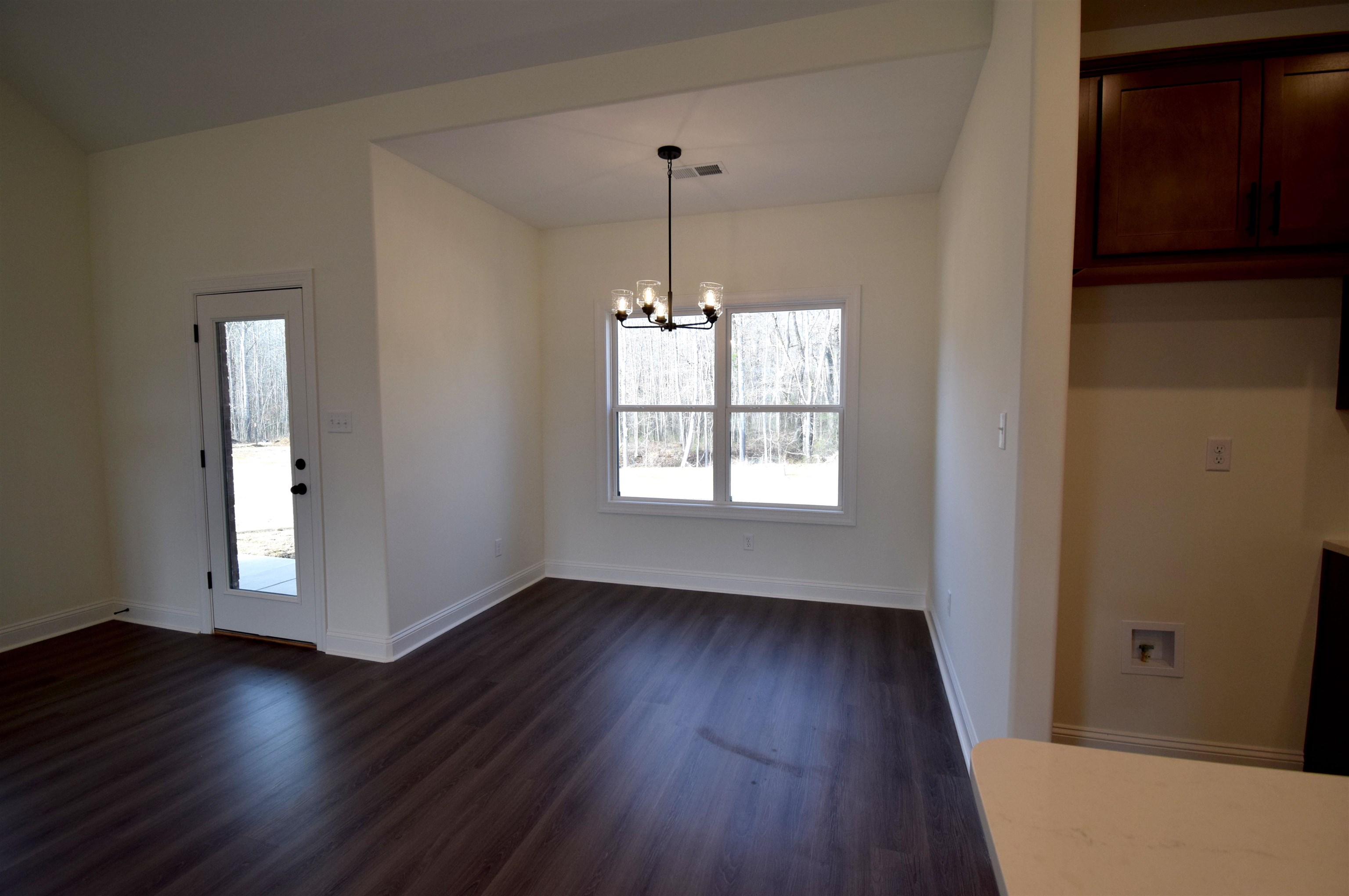 207 Centerline Roper Loop Byhalia, MS 38611 - Photo 11 of 23 an empty room with wooden floor and windows