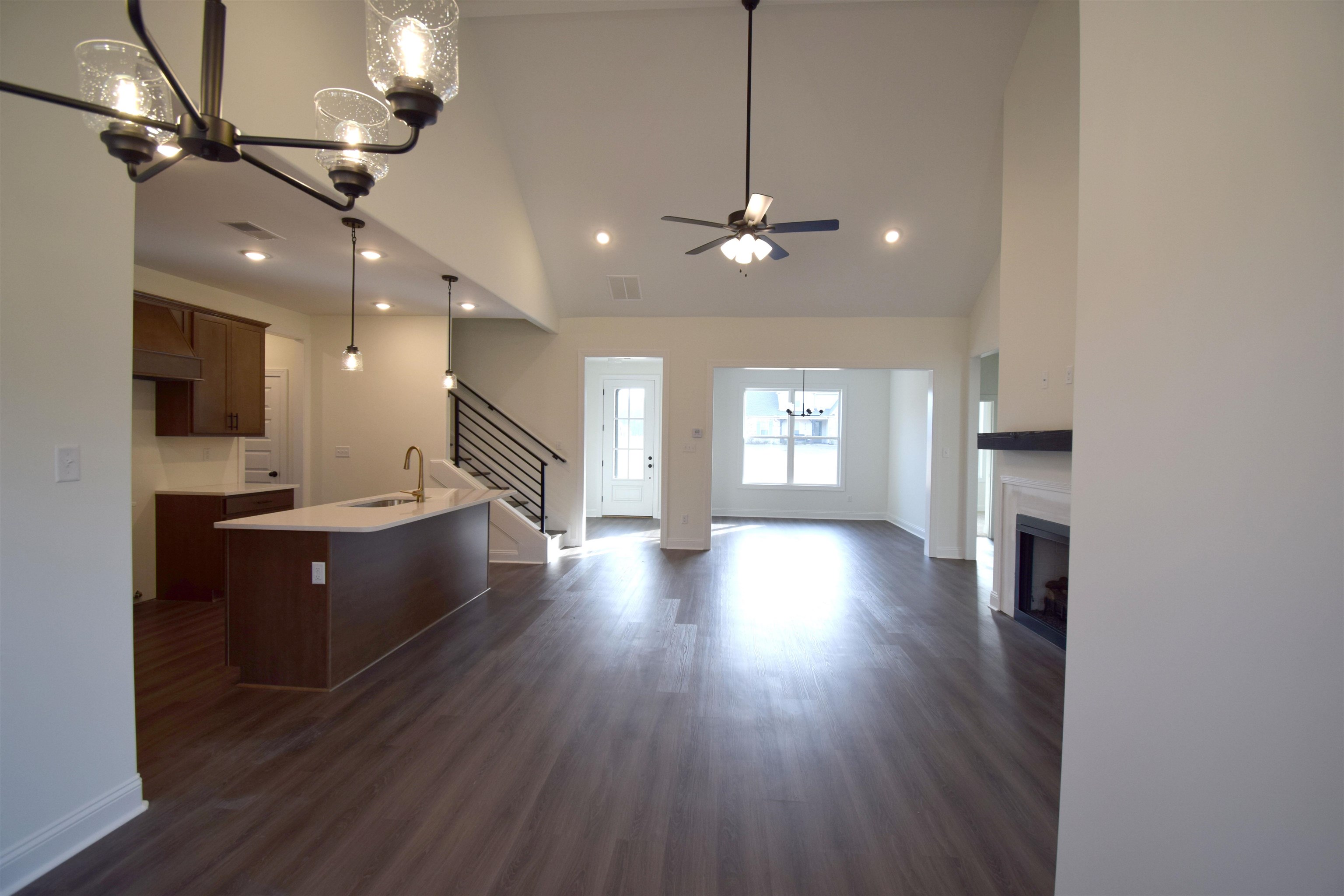 207 Centerline Roper Loop Byhalia, MS 38611 - Photo 12 of 23 a large hall with stainless steel appliances granite countertop a refrigerator a sink dishwasher a dining table and chairs with wooden floor