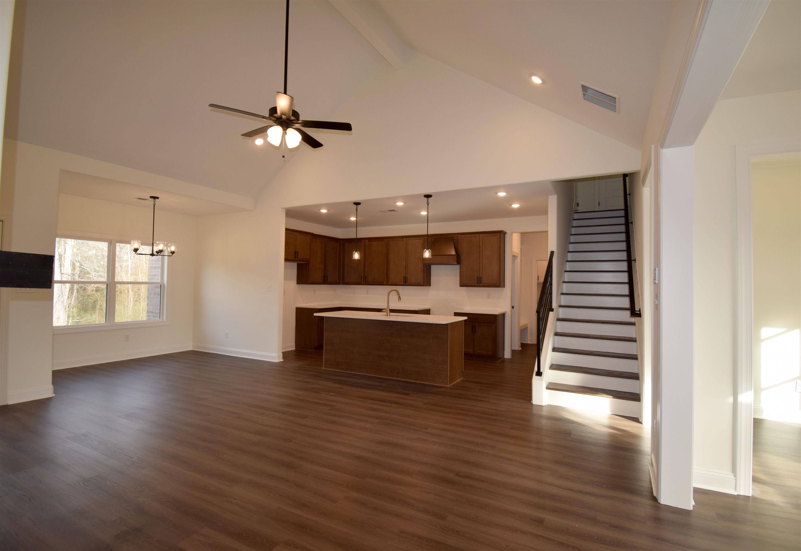 207 Centerline Roper Loop Byhalia, MS 38611 - Photo 16 of 23 a view of a livingroom with wooden floor and ceiling fan