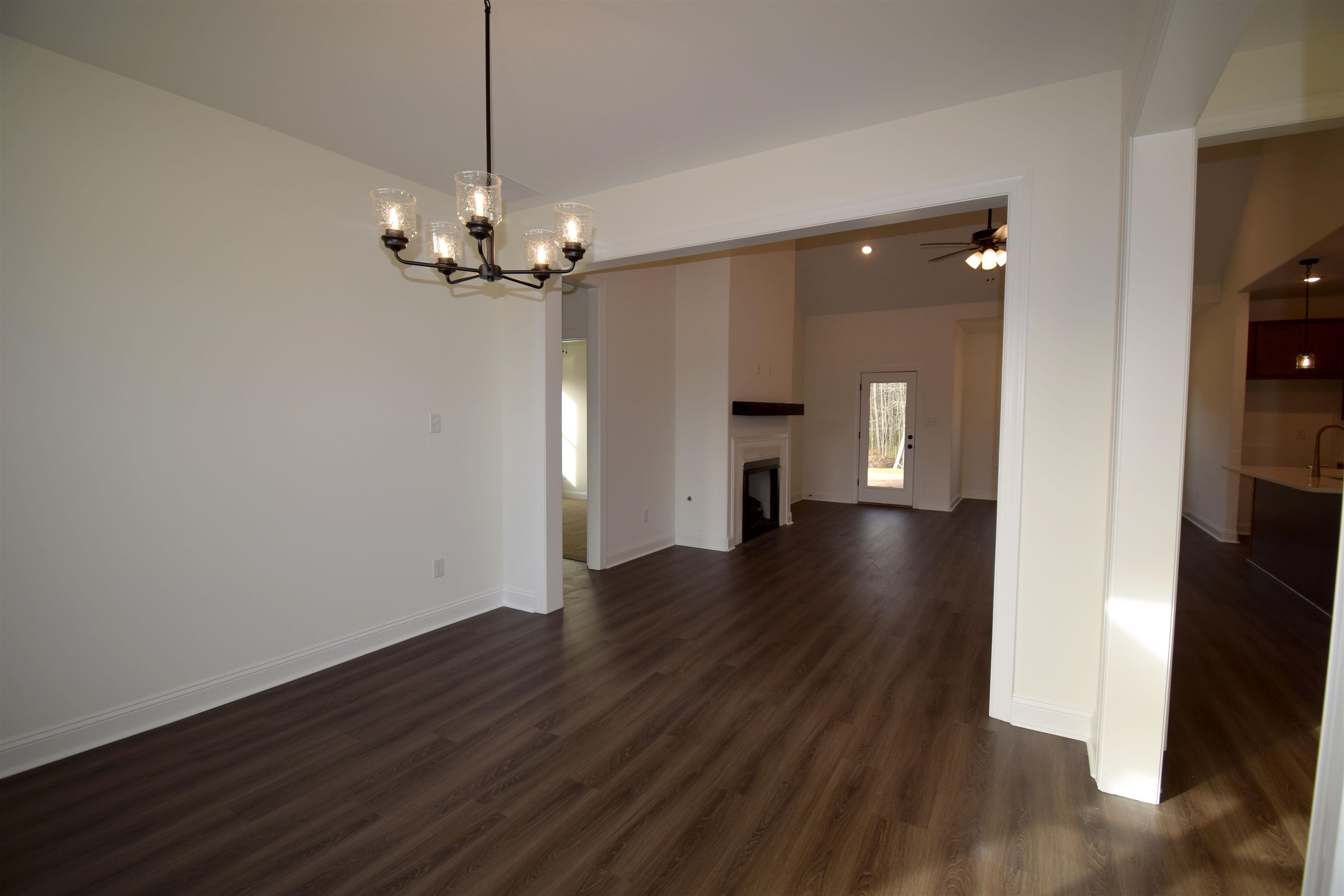 207 Centerline Roper Loop Byhalia, MS 38611 - Photo 2 of 23 a view of a room with wooden floor a ceiling fan and kitchen
