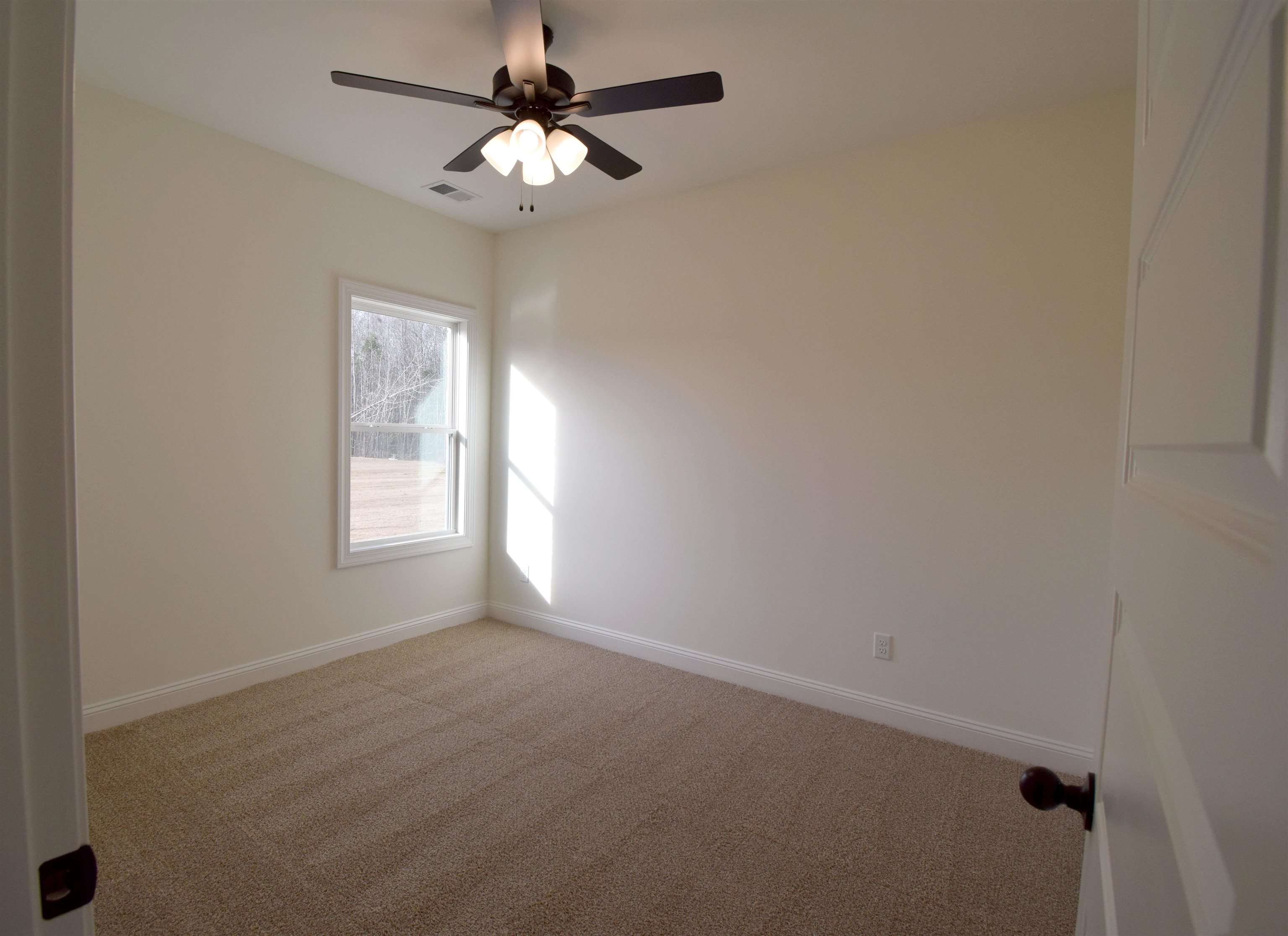 207 Centerline Roper Loop Byhalia, MS 38611 - Photo 9 of 23 an empty room with windows and fan