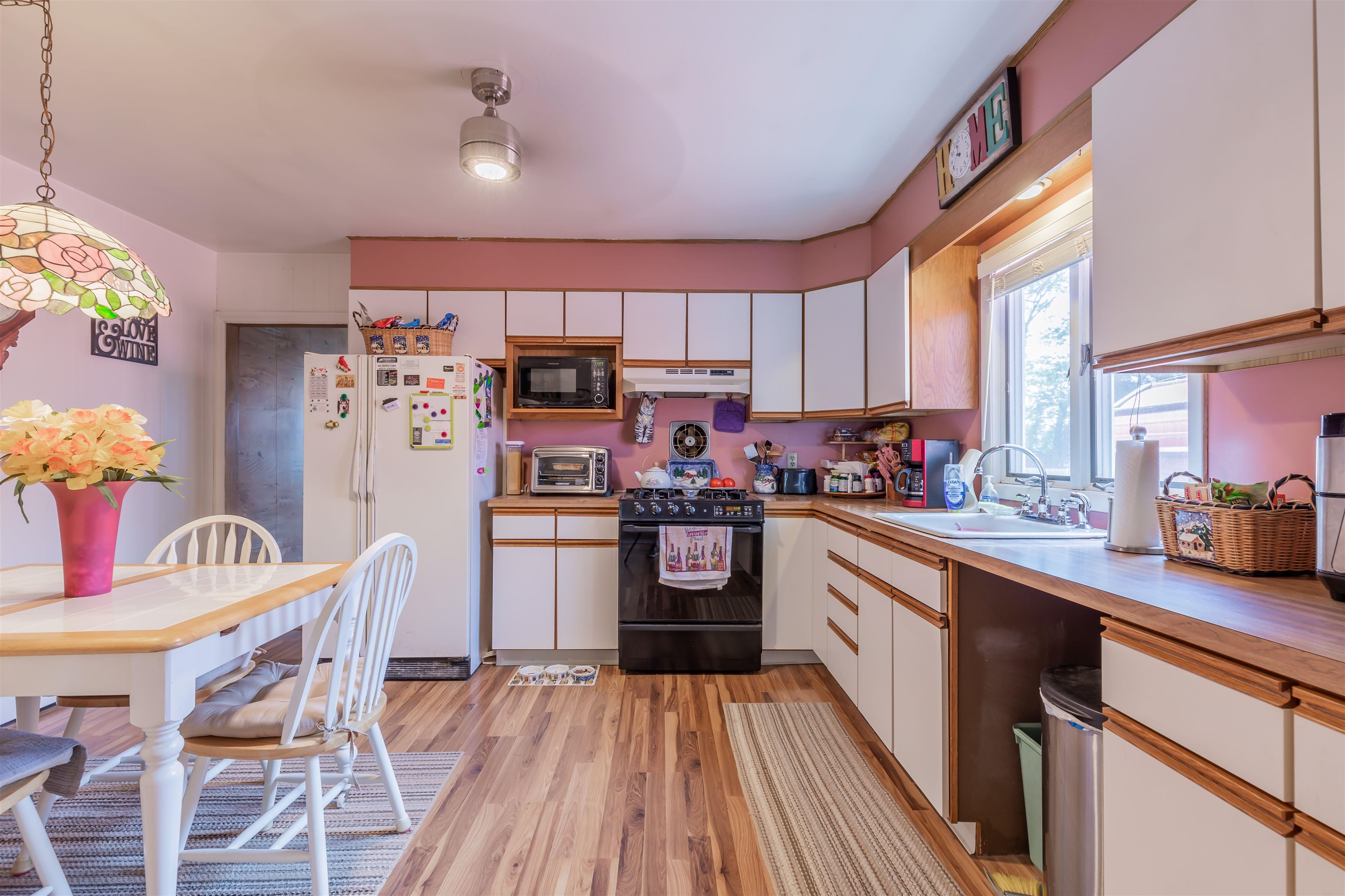 104 School Rio Grande, NJ 08242 - Photo 12 of 27 a kitchen with stainless steel appliances granite countertop a refrigerator a sink dishwasher a dining table and chairs with wooden floor