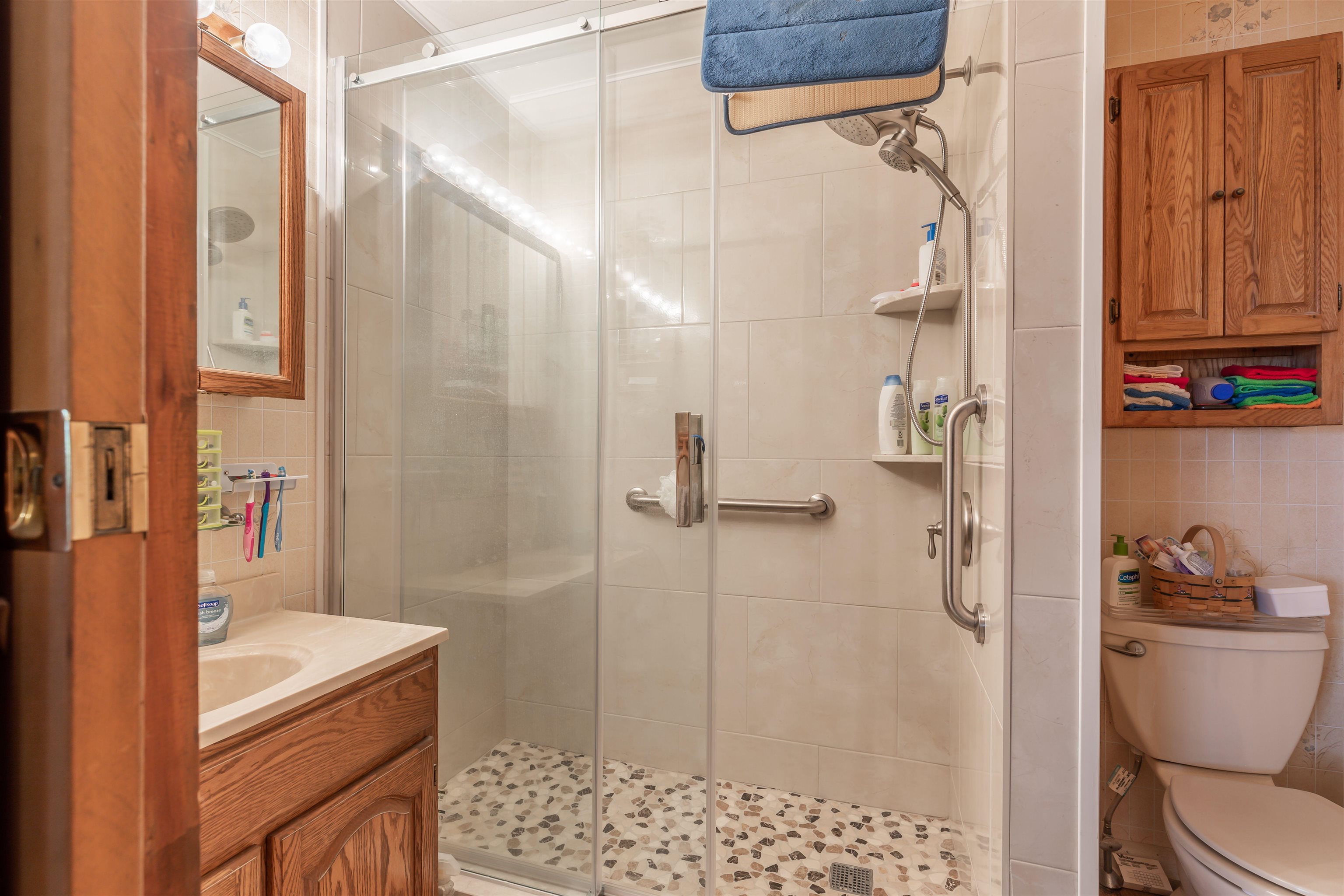 104 School Rio Grande, NJ 08242 - Photo 21 of 27 a bathroom with a granite countertop sink a toilet and shower