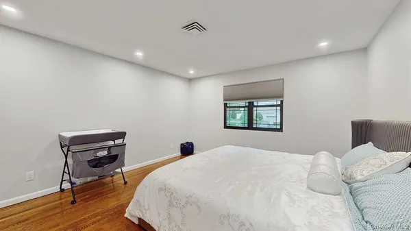 a bedroom with a bed and a workspace