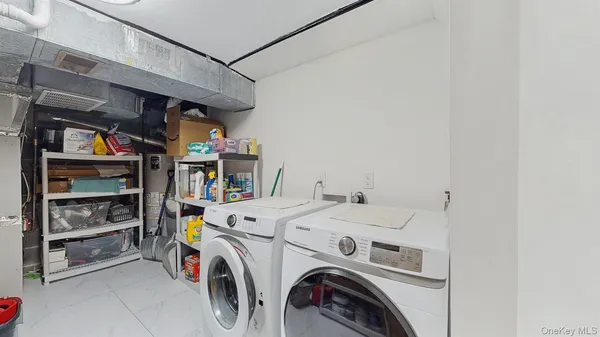a view of washer and dryer with kitchen in the background