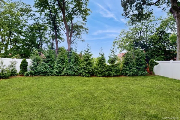 a view of a field of grass and trees