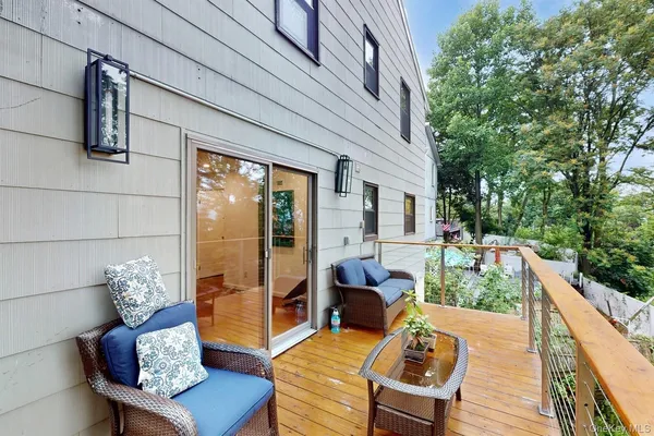 a balcony with furniture and wooden floor