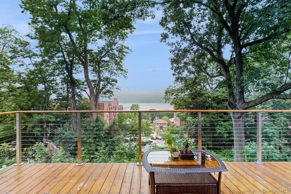 a view of balcony with deck and outdoor seating